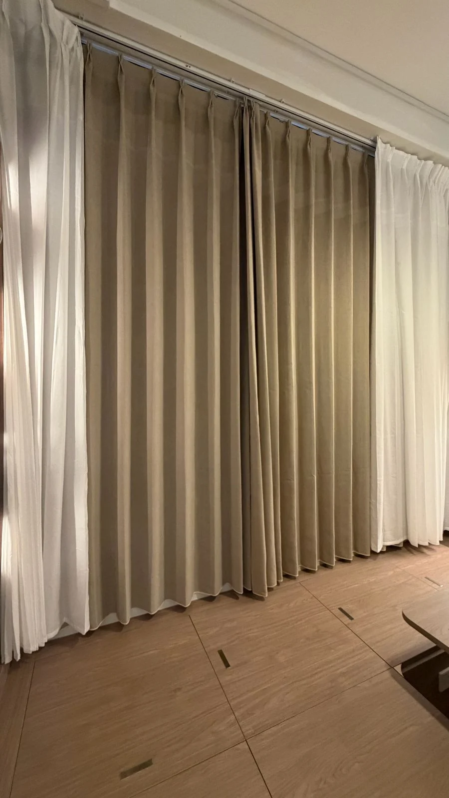 Taupe night curtains paired with white sheer curtains
