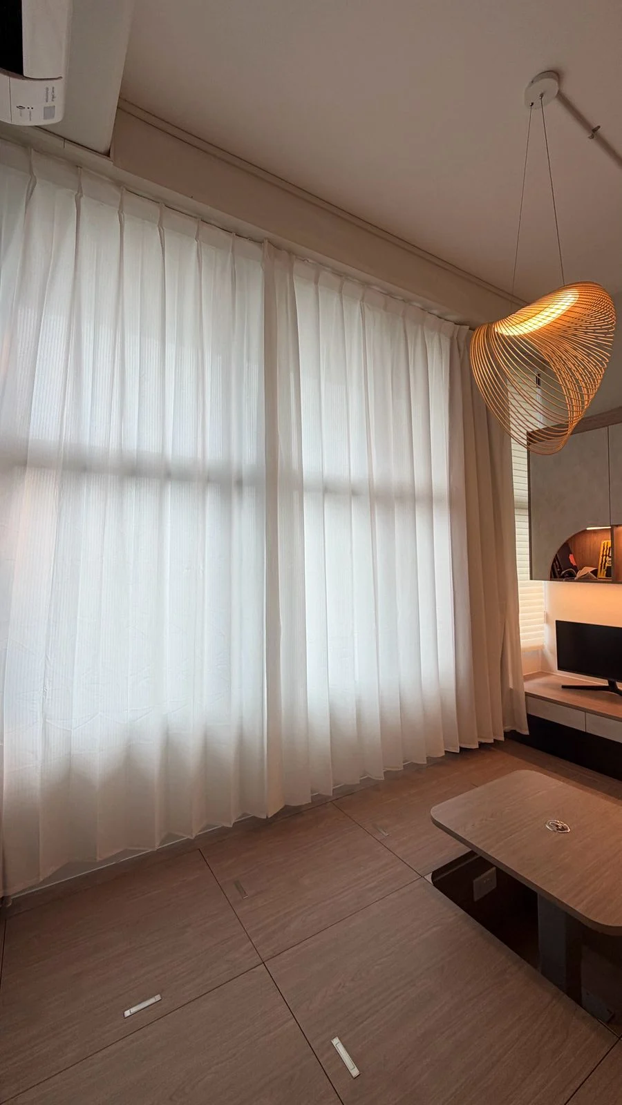 Full-height Griwa sheer curtains in a warm, lived-in interior